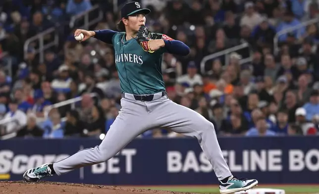 Seattle Mariners starting pitcher Bryan Woo (22) throws to a Toronto Blue Jays batter in the first inning of a baseball game in Toronto on Friday, April 18, 2025. (Jon Blacker/The Canadian Press via AP)