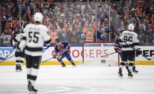 Edmonton Oilers' Connor McDavid (97) scores an empty net goal against the Los Angeles Kings during the third period of an NHL hockey playoff game in Edmonton, Alberta, Friday, April 25, 2025. (Jason Franson/The Canadian Press via AP)