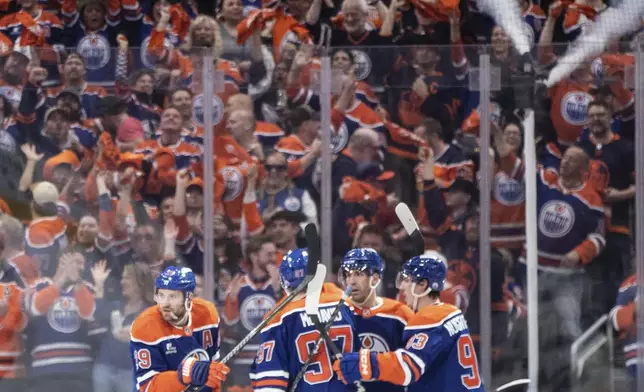 Edmonton Oilers players celebrate after a goal against the Los Angeles Kings during the first period of Game 3 of a first-round NHL hockey playoff series in Edmonton, Alberta, Friday, April 25, 2025. (Jason Franson/The Canadian Press via AP)
