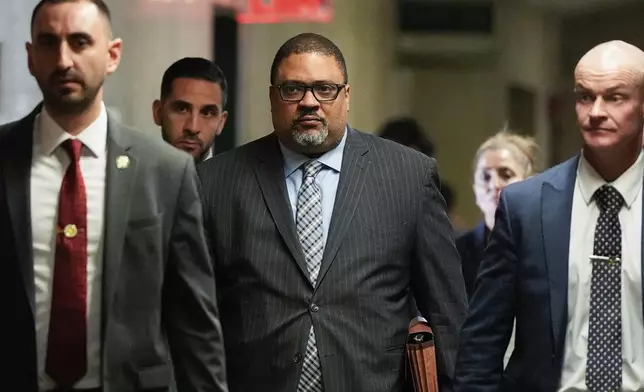 Manhattan district attorney Alvin Bragg, center, walks through Manhattan criminal court, Tuesday, April 22, 2025, the day of Harvey Weinstein's retrial in New York. (AP Photo/Julia Demaree Nikhinson)