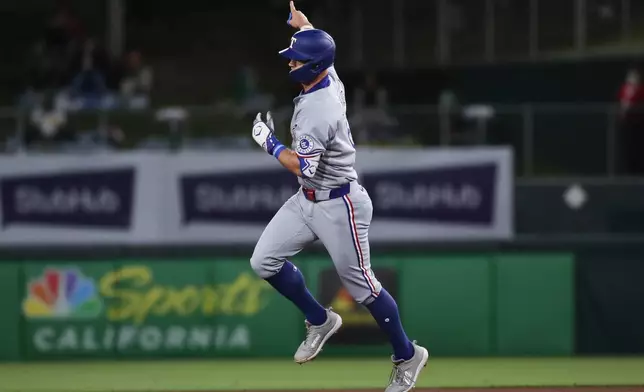 Texas Rangers Josh Jung reacts after hitting a homer against the Athletics during the fourth inning of a baseball game Thursday, April 24, 2025, in West Sacramento, Calif. (AP Photo/Scott Marshall)