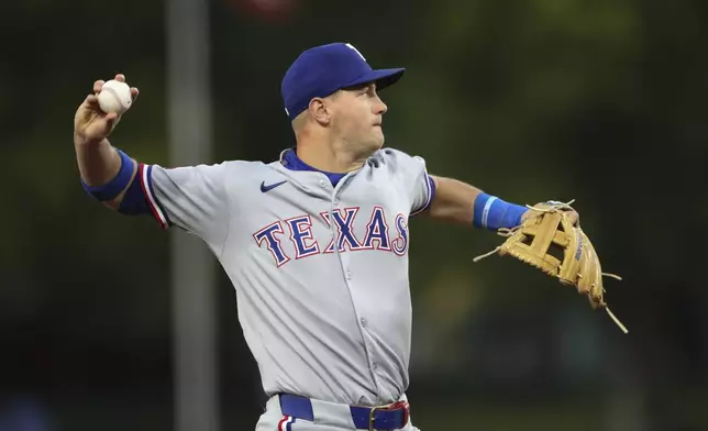 Texas Rangers third baseman Josh Jung throws to first for an out against the Athletics during the second inning of a baseball game Thursday, April 24, 2025, in West Sacramento, Calif. (AP Photo/Scott Marshall)