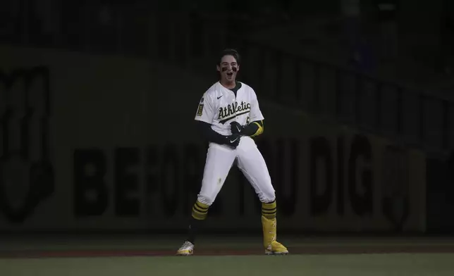 Athletics Jacob Wilson (5) reacts after hitting a walk-off single against the Texas Rangers during the ninth inning of a baseball game Thursday, April 24, 2025, in West Sacramento, Calif. (AP Photo/Scott Marshall)