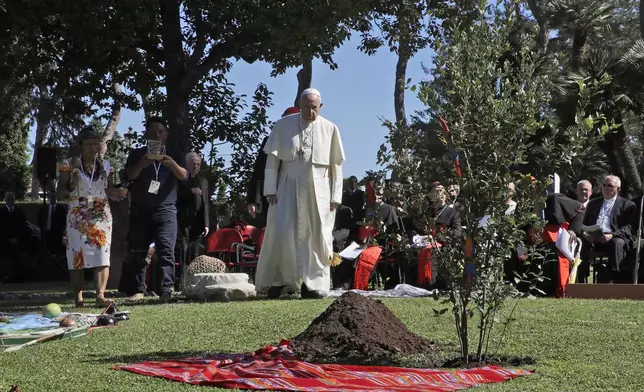FILE - Pope Francis walks towards a newly planted oak tree during a tree-planting ceremony during the feast of St. Francis of Assisi, the patron saint of ecology, at the Vatican, Oct. 4, 2019. (AP Photo/Alessandra Tarantino, File)