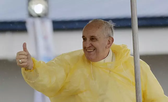 FILE - Pope Francis gives a thumbs up to the faithful as he arrives in Tacloban, Philippines, Jan. 17, 2015. (AP Photo/Wally Santana, File)