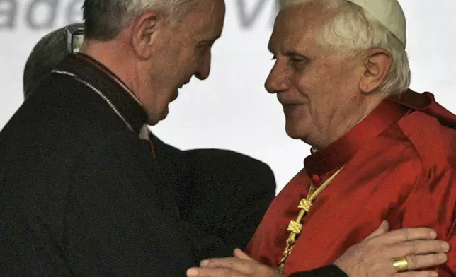 FILE - Pope Benedict XVI, right, embraces Cardinal Jorge Bergoglio, Archbishop of Buenos Aires, during a conference of Latin American and Caribbean bishops in Aparecida, Brazil, May 13, 2007. (AP Photo/Ricardo Mazalan, File)