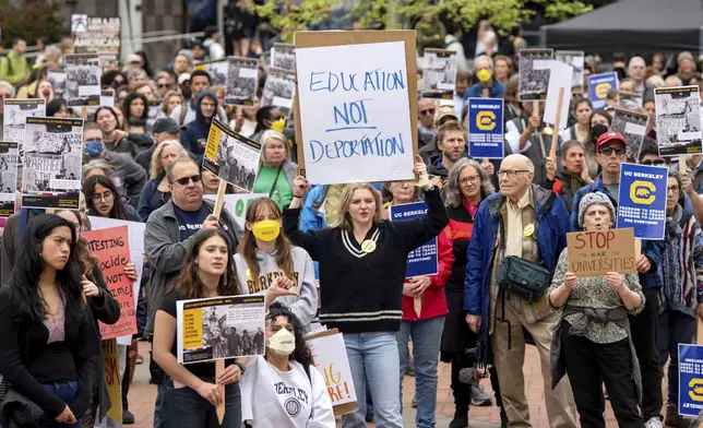University of California, Berkeley undergraduate Eva Winter holds a sign over her head while protesting against the Trump administration during a Day of Action for Higher Education on Thursday, April 17, 2025, in Berkeley, Calif. (AP Photo/Noah Berger)