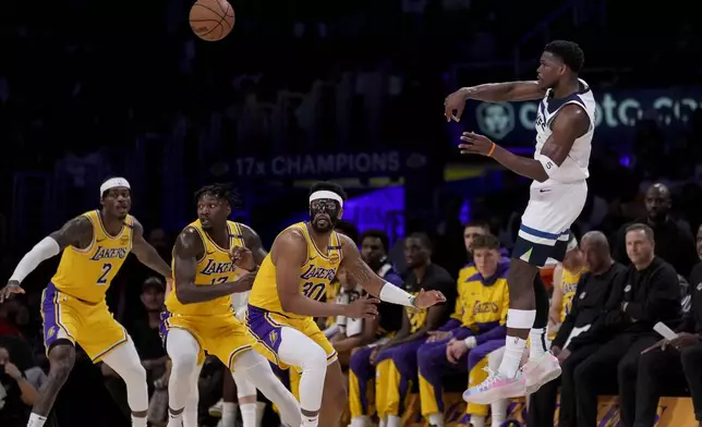 Minnesota Timberwolves guard Anthony Edwards (5) passes during the first half of Game 2 of an NBA first-round playoff series against the Los Angeles Lakers in Los Angeles, Tuesday, April 22, 2025. (AP Photo/Eric Thayer)