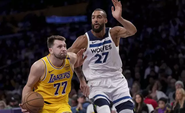Los Angeles Lakers guard Luka Doncic (77) goes to the basket against Minnesota Timberwolves center Rudy Gobert (27) during the first half of Game 2 of an NBA first-round playoff series in Los Angeles, Tuesday, April 22, 2025. (AP Photo/Eric Thayer)