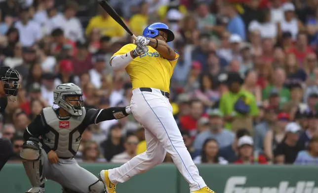 Boston Red Sox's Rafael Devers, right, follows through on his swing as he hits a three-run home run in front of Chicago White Sox catcher Edgar Quero, left, in the fifth inning of a baseball game, Saturday, April 19, 2025, in Boston. (AP Photo/Steven Senne)