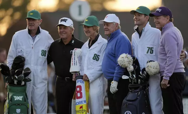 From left: Honorary Starters Gary Player, Jack Nicklaus, and Tom Watson stand with their caddies as they pose on the first hole during the first round at the Masters golf tournament, Thursday, April 10, 2025, in Augusta, Ga. (AP Photo/David J. Phillip)