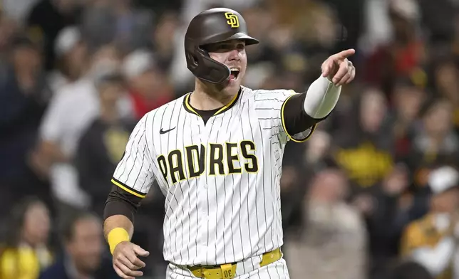 San Diego Padres' Gavin Sheets (30) points to first base after scoring during the sixth inning of a baseball game against the Chicago Cubs, Monday, April 14, 2025, in San Diego, Calif. (AP Photo/Denis Poroy)