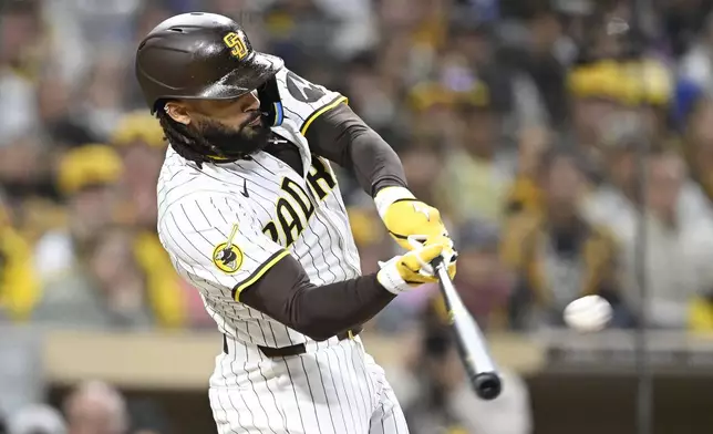 San Diego Padres' Fernando Tatis Jr. hits a solo home run during the third inning of a baseball game against the Chicago Cubs, Monday, April 14, 2025, in San Diego, Calif. (AP Photo/Denis Poroy)