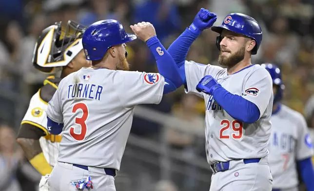 Chicago Cubs' Michael Busch (29), right, is congratulated by Justin Turner (3) after hitting a two-run home run during the fourth inning of a baseball game against the San Diego Padres, Monday, April 14, 2025, in San Diego, Calif. (AP Photo/Denis Poroy)