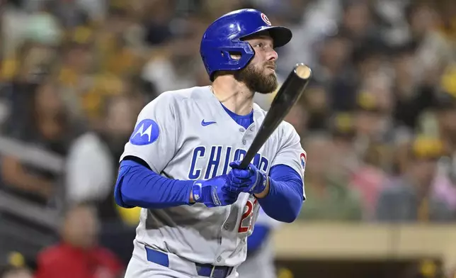 Chicago Cubs' Michael Busch watches his two-run home run during the fourth inning of a baseball game against the San Diego Padres, Monday, April 14, 2025, in San Diego, Calif. (AP Photo/Denis Poroy)