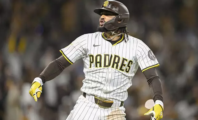 San Diego Padres' Fernando Tatis Jr. (23) celebrates after hitting a two-run home run during the eighth inning of a baseball game against the Chicago Cubs, Monday, April 14, 2025, in San Diego, Calif. (AP Photo/Denis Poroy)