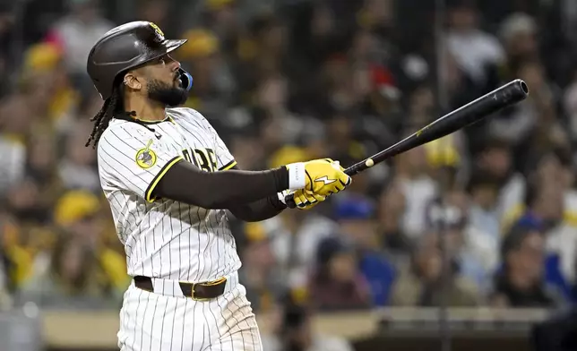 San Diego Padres' Fernando Tatis Jr. (23) hits a two-run home run during the eighth inning of a baseball game against the Chicago Cubs Monday, April 14, 2025, in San Diego, Calif. (AP Photo/Denis Poroy)