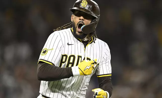 San Diego Padres' Fernando Tatis Jr. (23) celebrates after hitting a two-run home run during the eighth inning of a baseball game against the Chicago Cubs Monday, April 14, 2025, in San Diego, Calif. (AP Photo/Denis Poroy)