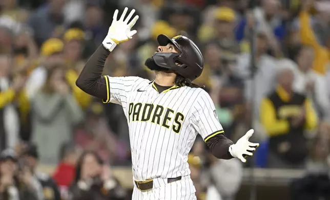 San Diego Padres' Fernando Tatis Jr. looks skyward after hitting a solo home run during the third inning of a baseball game against the Chicago Cubs, Monday, April 14, 2025, in San Diego, Calif. (AP Photo/Denis Poroy)
