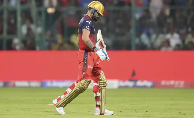 Royal Challengers Bengaluru's Virat Kohli walks off the field after losing his wicket during the Indian Premier League cricket match between Royal Challengers Bengaluru and Delhi Capitals at Chinnaswamy Stadium in Bengaluru, India, Thursday, April 10, 2025. (AP Photo/Aijaz Rahi)