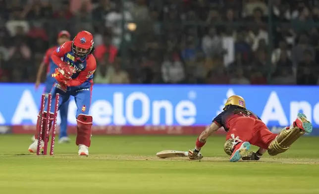 Royal Challengers Bengaluru's Phil Salt, right, is run-out by Delhi Capitals' wicketkeeper KL Rahul during the Indian Premier League cricket match between Royal Challengers Bengaluru and Delhi Capitals at Chinnaswamy Stadium in Bengaluru, India, Thursday, April 10, 2025. (AP Photo/Aijaz Rahi)