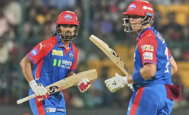 Delhi Capitals' KL Rahul, left, and his batting partner Tristan Stubbs run between the wickets to score during the Indian Premier League cricket match between Royal Challengers Bengaluru and Delhi Capitals at Chinnaswamy Stadium in Bengaluru, India, Thursday, April 10, 2025. (AP Photo/Aijaz Rahi)