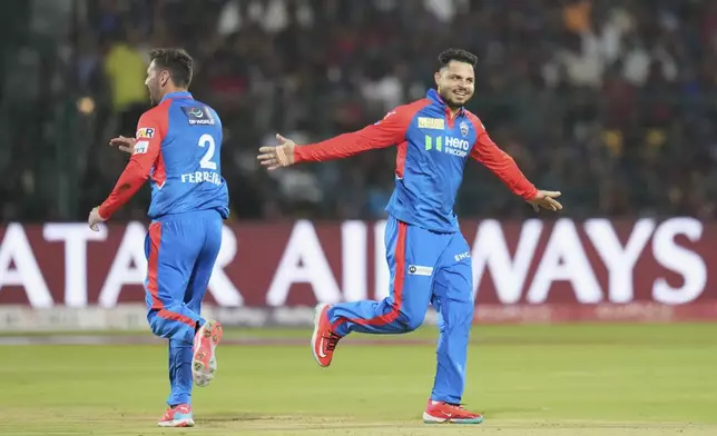 Delhi Capitals' Ashutosh Sharma, right, celebrates after taking the catch to dismiss Royal Challengers Bengaluru's Liam Livingstone during the Indian Premier League cricket match between Royal Challengers Bengaluru and Delhi Capitals at Chinnaswamy Stadium in Bengaluru, India, Thursday, April 10, 2025. (AP Photo/Aijaz Rahi)