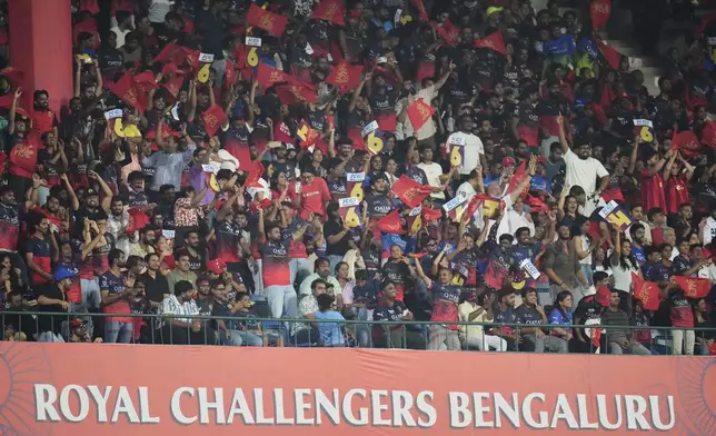 Royal Challengers Bengaluru fans cheer for their team during the Indian Premier League cricket match between Royal Challengers Bengaluru and Delhi Capitals at Chinnaswamy Stadium in Bengaluru, India, Thursday, April 10, 2025. (AP Photo/Aijaz Rahi)