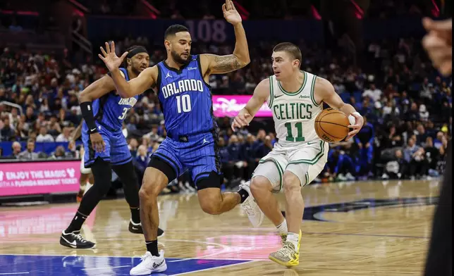 Orlando Magic guard Cory Joseph (10) defends Boston Celtics guard Payton Pritchard (11) as he brings the ball into the lane during the first half of an NBA basketball game, Wednesday, April 9, 2025, in Orlando, Fla. (AP Photo/Kevin Kolczynski)