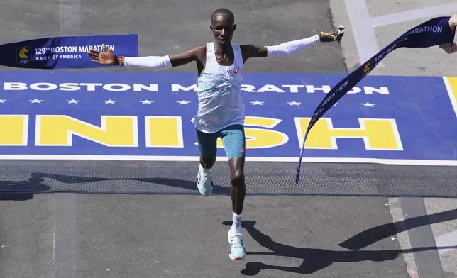 John Korir, of Kenya, breaks the tape to win the Boston Marathon, Monday, April 21, 2025, in Boston. (AP Photo/Charles Krupa)