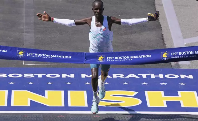 John Korir, of Kenya, breaks the tape to win the Boston Marathon, Monday, April 21, 2025, in Boston. (AP Photo/Charles Krupa)
