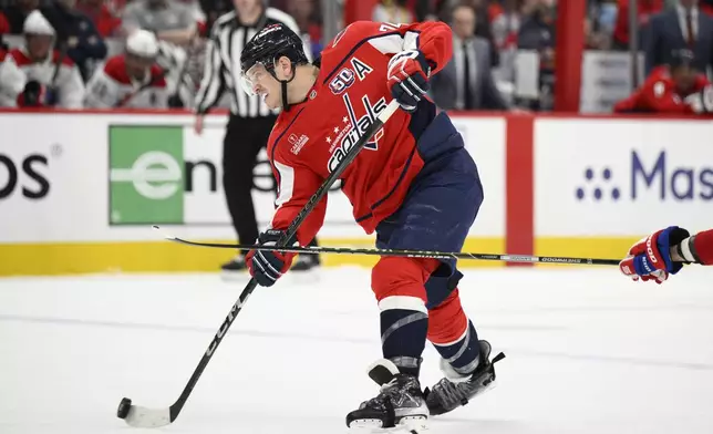 Washington Capitals defenseman John Carlson (74) shoots the puck in the first period of Game 2 of a first-round NHL hockey playoff series against the Montreal Canadiens Wednesday, April 23, 2025, in Washington. (AP Photo/Nick Wass)