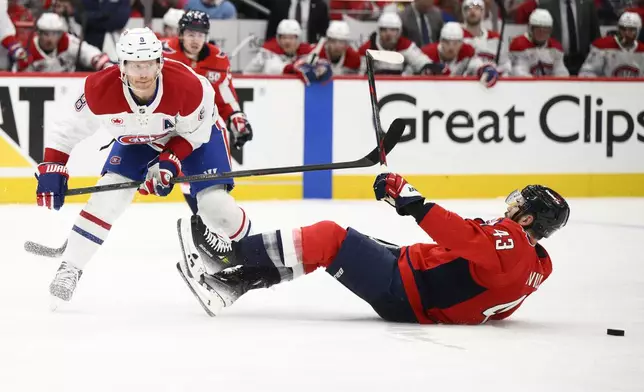 Montreal Canadiens defenseman Mike Matheson (8) battles for the puck against Washington Capitals right wing Tom Wilson (43) in the second period of Game 2 of a first-round NHL hockey playoff series Wednesday, April 23, 2025, in Washington. (AP Photo/Nick Wass)