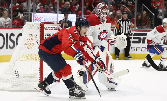 Washington Capitals left wing Anthony Beauvillier (72) reaches for the puck past Montreal Canadiens goaltender Sam Montembeault (35) in the first period of Game 2 of a first-round NHL hockey playoff series, Wednesday, April 23, 2025, in Washington. (AP Photo/Nick Wass)