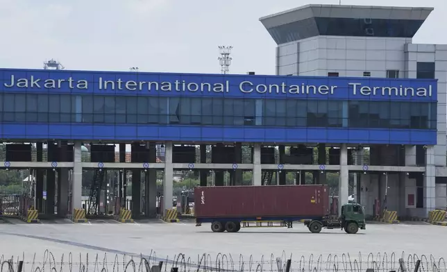 A truck container drives past the Jakarta International container terminal at Tanjung Priok seaport in Jakarta, Indonesia, Thursday, April 3, 2025. (AP Photo/Achmad Ibrahim)