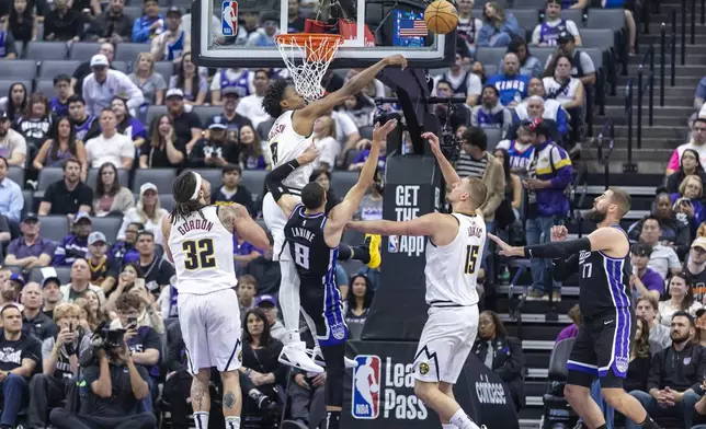 Denver Nuggets forward Peyton Watson (8) blocks Sacramento Kings guard Zach LaVine's (8) layup during the first half of an NBA basketball game Wednesday, April 9, 2025, in Sacramento, Calif. (AP Photo/Sara Nevis)