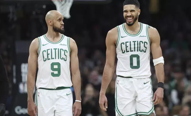 Boston Celtics' Jayson Tatum (0), right, reacts beside Derrick White after falling on a flagrant fowl by Orlando Magic's Kentavious Caldwell-Pope during the second half in Game 1 of a first-round NBA playoff basketball series Sunday, April 20, 2025, in Boston. (AP Photo/Michael Dwyer)