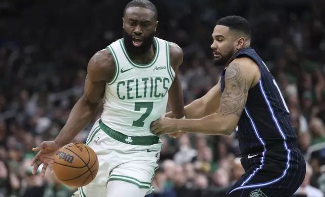 Boston Celtics' Jaylen Brown (7) drives past Orlando Magic's Cory Joseph during the first half in game 1 of a first-round NBA playoff basketball series Sunday, April 20, 2025, in Boston. (AP Photo/Michael Dwyer)