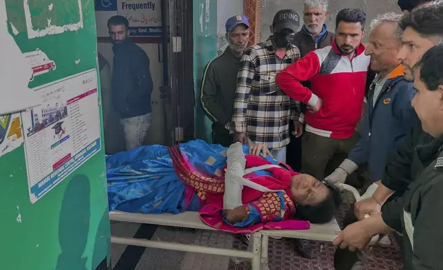 Paramedics carry a wounded tourist on a stretcher at a hospital in Anantnag after assailants indiscriminately fired at tourists visiting Pahalgam, Indian controlled Kashmir, Tuesday, April 22, 2025.(AP Photo/Dar Yasin)