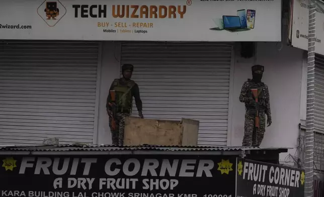 Indian paramilitary soldiers guard near a clock tower at city centre in Srinagar, Indian controlled Kashmir,Tuesday, April. 22, 2025. (AP Photo/Mukhtar Khan)