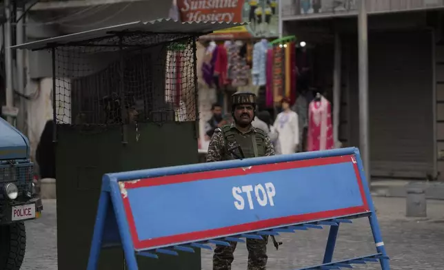 Indian paramilitary soldiers guard near a clock tower at city centre in Srinagar, Indian controlled Kashmir,Tuesday, April. 22, 2025. (AP Photo/Mukhtar Khan)