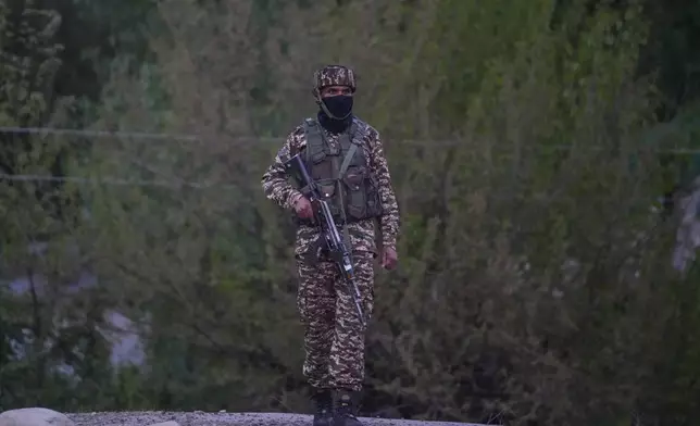 An Indian security officer stands guard in south Kashmir after assailants indiscriminately opened fired at tourists in Pahalgam, Indian controlled Kashmir, Tuesday, April 22, 2025. (AP Photo/Dar Yasin)