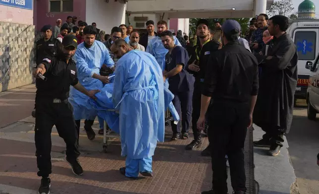 Paramedic carries a wounded tourist on a stretcher at a hospital in Anantnag after assailants indiscriminately fired at tourists visiting Pahalgam, Indian controlled Kashmir, Tuesday, April 22, 2025.(AP Photo/Dar Yasin)