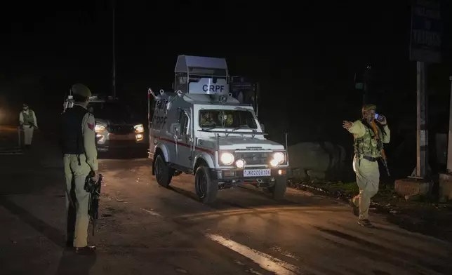 Indian police officers stands guard at a check point near Pahalgam in south Kashmir after assailants indiscriminately opened fired at tourists visiting Pahalgam, Indian controlled Kashmir, Tuesday, April 22, 2025.(AP Photo/Dar Yasin)