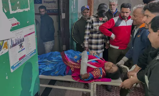 Paramedic carry a wounded tourist on a stretcher at a hospital in Anantnag after assailants indiscriminately fired at tourists visiting Pahalgam, Indian controlled Kashmir, Tuesday, April 22, 2025.(AP Photo/Dar Yasin)