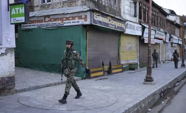 An Indian security officer patrols a shopping area in Pahalgam a day after militants indiscriminately opened fire on tourists near the town, Indian controlled Kashmir, Wednesday, April 23, 2025. (AP Photo/Dar Yasin)