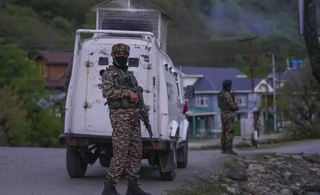 Indian security officers stand guard on a highway in south Kashmir after assailants indiscriminately opened fired at tourists in Pahalgam, Indian controlled Kashmir, Tuesday, April 22, 2025. (AP Photo/Dar Yasin)