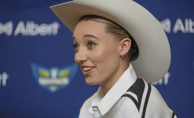 Dallas Wings' Paige Bueckers, selected No. 1 overall in the WNBA basketball draft, sports a cowboy hat gifted to her during an introductory press conference Wednesday, April 23, 2025, in Dallas. (AP Photo/Julio Cortez)