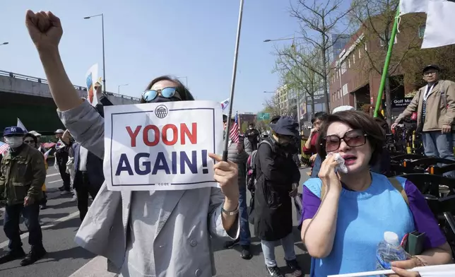 A supporter of recently ousted South Korean President Yoon Suk Yeol weeps during a rally to oppose his impeachment near the the presidential residence in Seoul, South Korea, Friday, April 11, 2025. (AP Photo/Ahn Young-joon)
