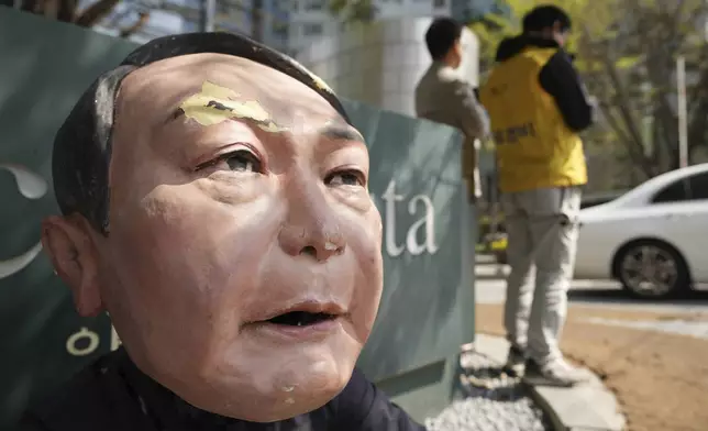A person protesting against recently removed South Korean President Yoon Suk Yeol wears a mask depicting him near Yoon's private residence in Seoul, South Korea, Friday, April 11, 2025. (AP Photo/Lee Jin-man)